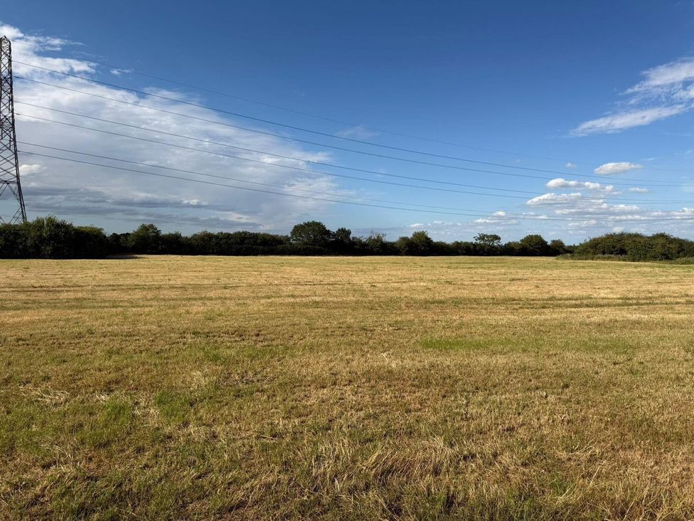 A field with power lines and trees at Surridges Studio, Sleeps 4 w/ Parking & Dogs Ok in Latchingdon near Burnham-On-Crouch