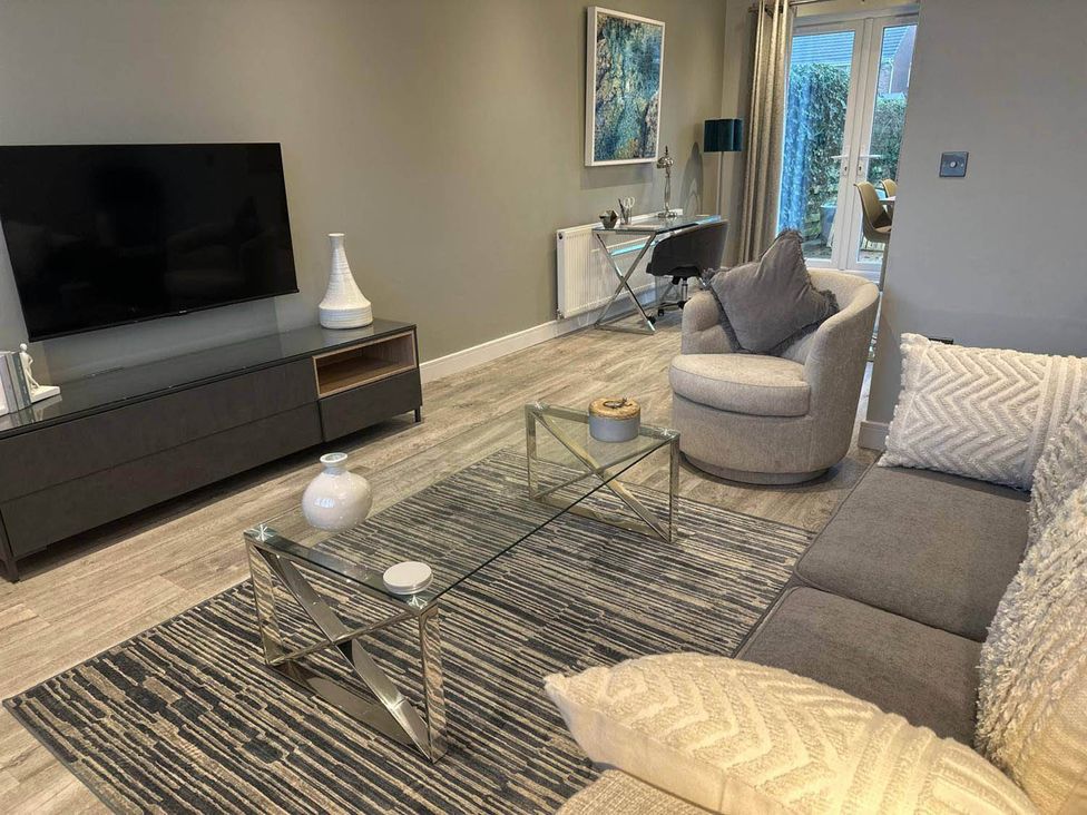 A living room with a television and seating area at Stylish Home Sleeps 4 Free Parking in Earl Shilton