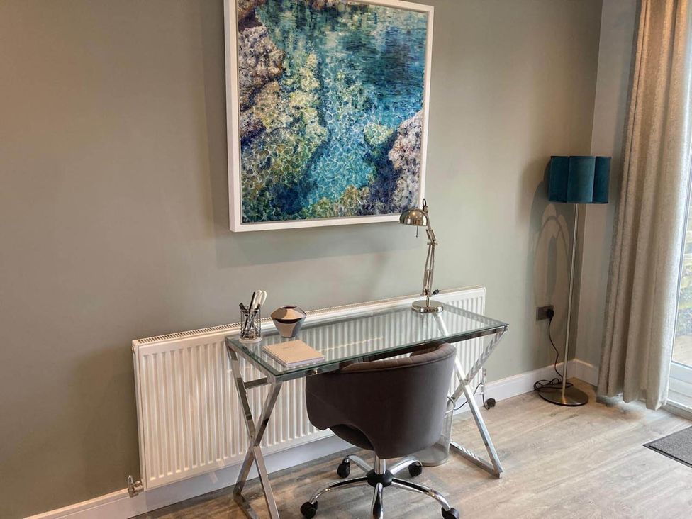 An office with a glass desk and chair at Stylish Home Sleeps 4 Free Parking in Earl Shilton