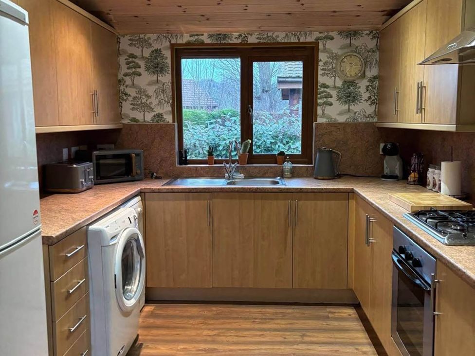 A kitchen with appliances and a window at Cabin Sleeps 4 with Hot Tub and Parking near Wilberfoss
