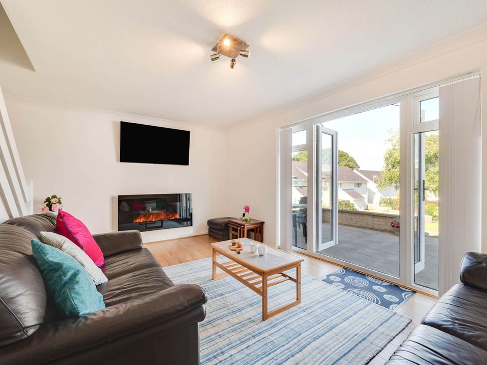 A living room with a sofa, coffee table, and television at Ty Gwyn Borth-y-gest House Sleeps 5 Garden Parking Borth-Y-Gest