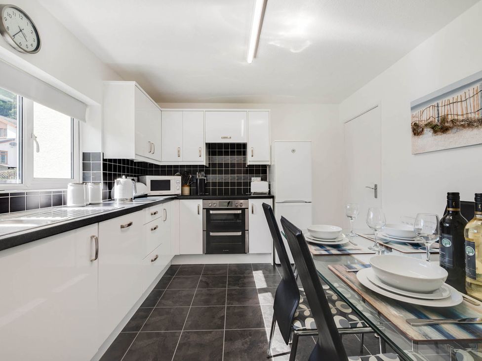 A kitchen with a table set for dining at Ty Gwyn Borth-y-gest House Sleeps 5 Garden Parking in Borth-Y-Gest