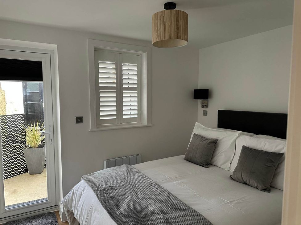 A bedroom with a bed and window at 59 Whitstable - One Bedroom Ground Floor Flat in Whitstable