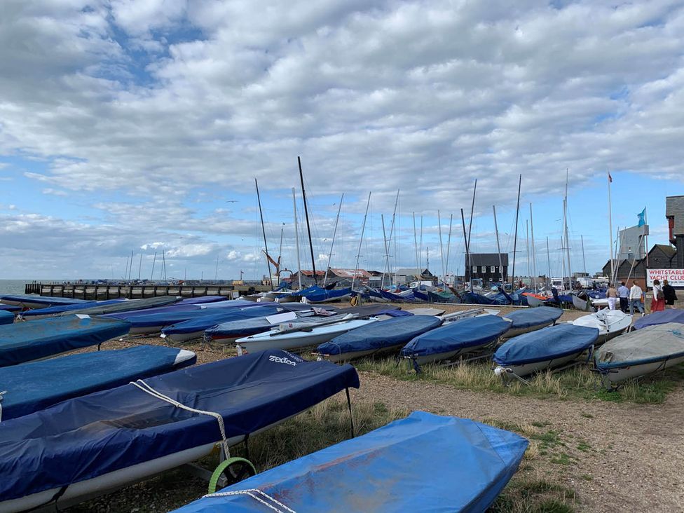 A view of boats and a pier at Whitstable Yacht Club in Whitstable