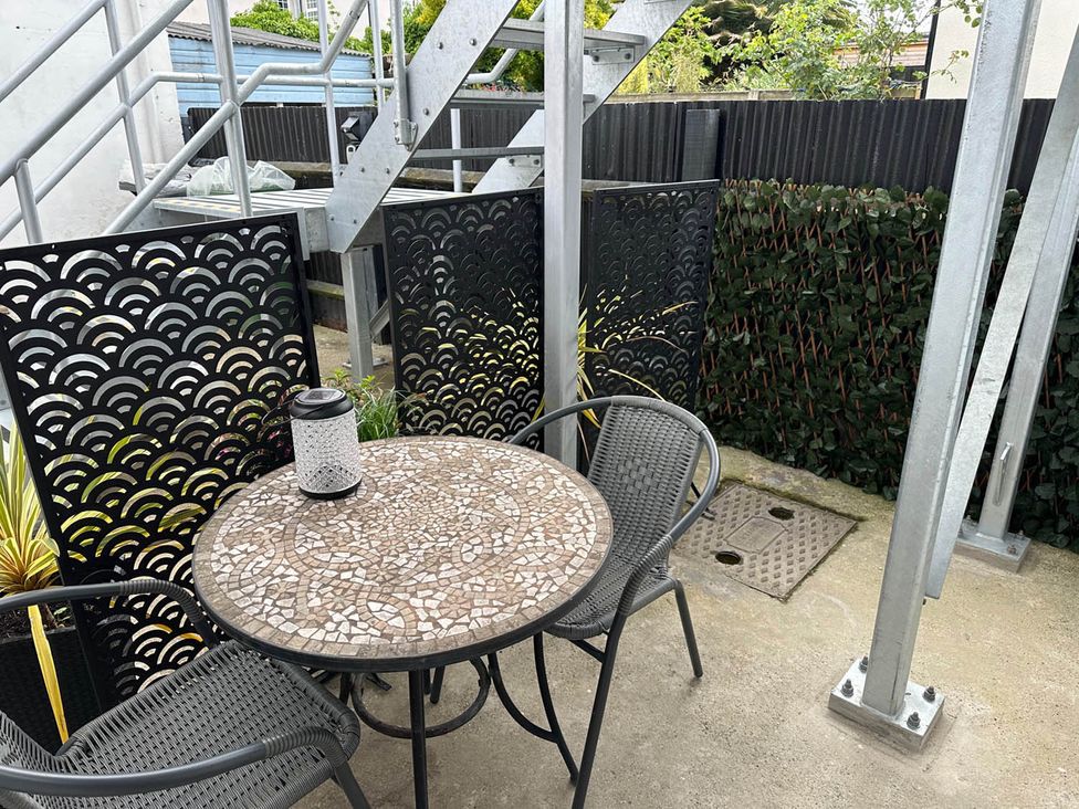 A patio with a table and chairs at 59 Whitstable - One Bedroom Ground Floor Flat in Whitstable