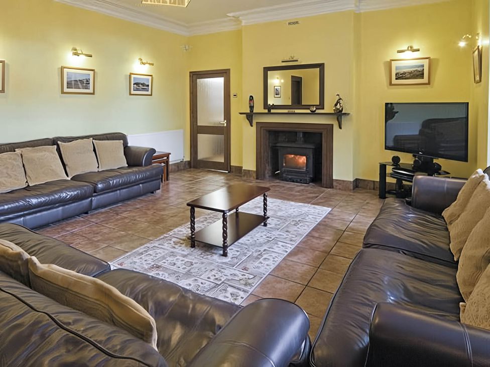 A living room with sofas and a coffee table at The Old Barn in Barmouth