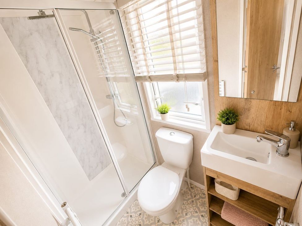 A bathroom with a shower, toilet, and sink at Cala Gran 3Bed Caravan Sleeps 8 Wrap Decking Fleetwood