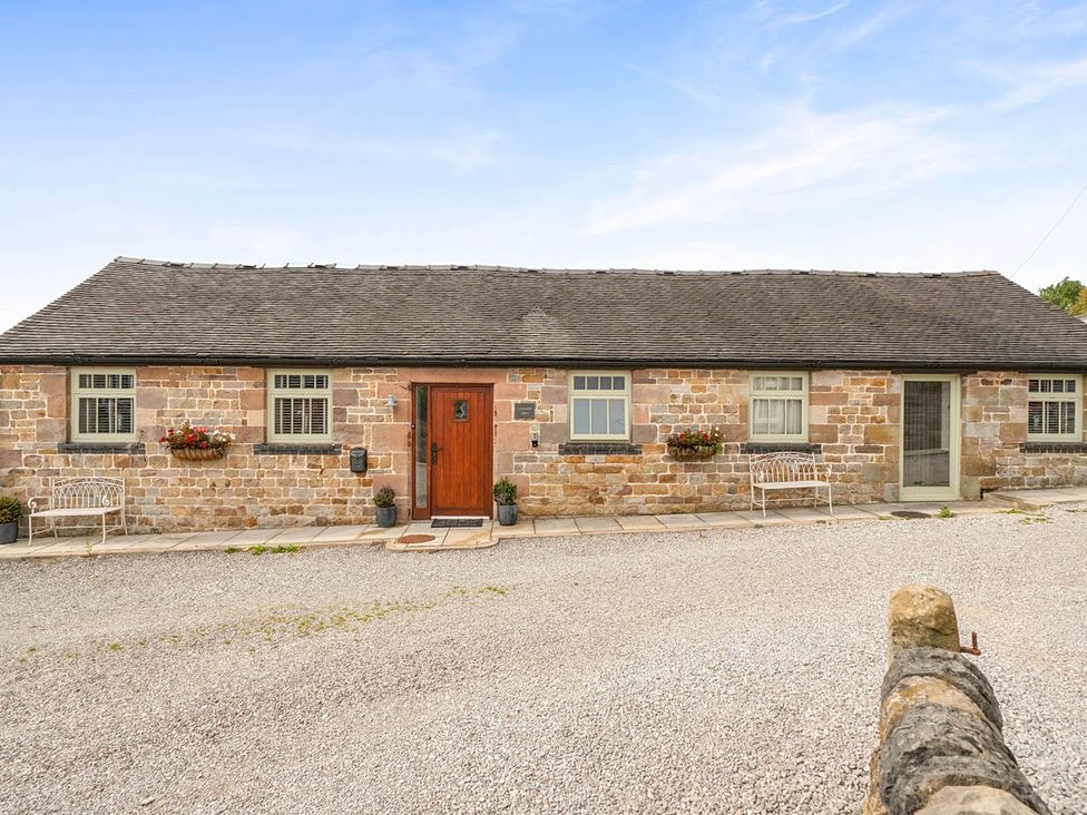 A cottage with stone walls and a wooden door at the property near Waterhouses