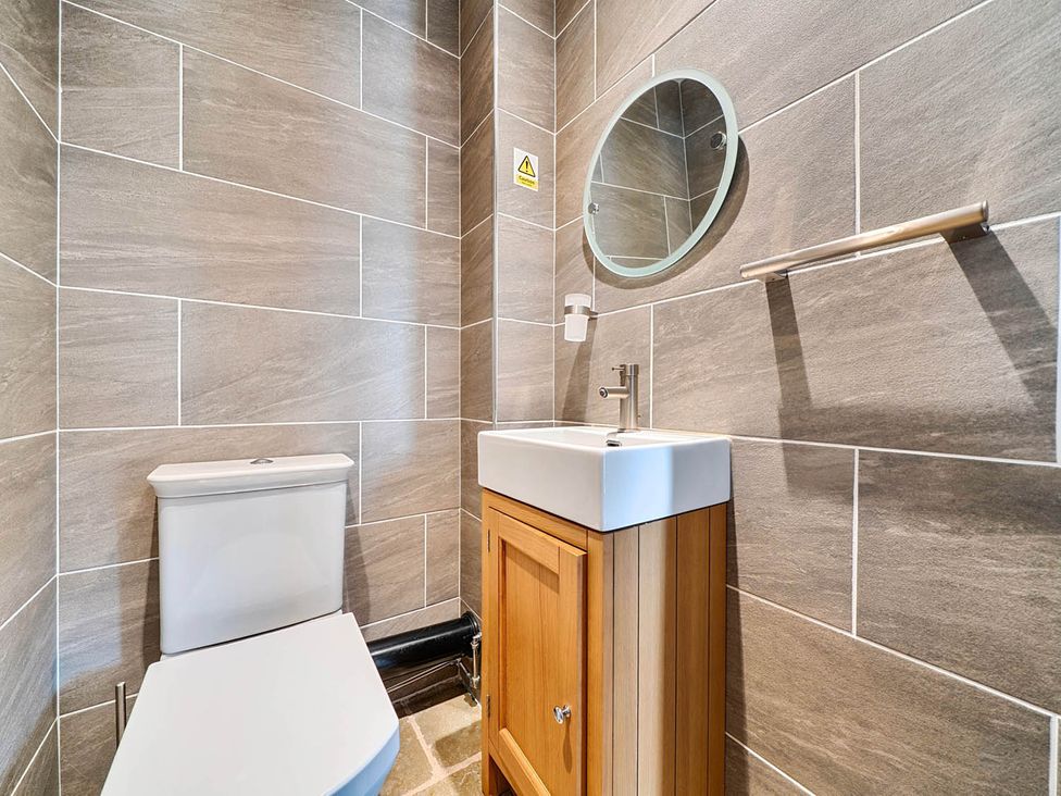 A bathroom with a sink and toilet at The Old Barn Near Waterhouses