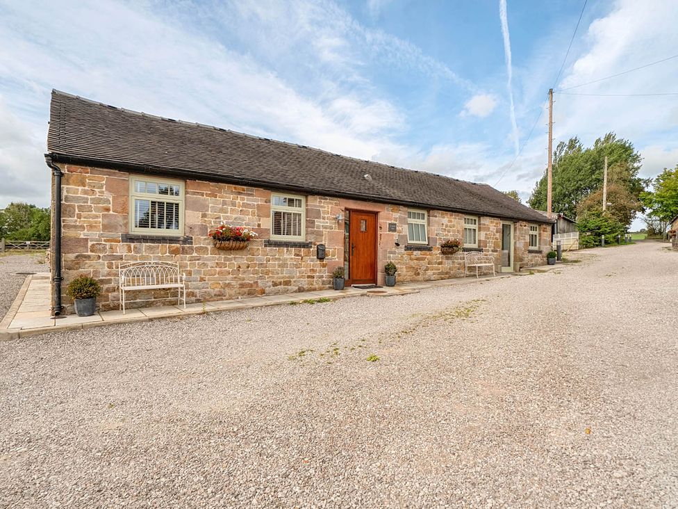 A stone building with a front door and windows near Waterhouses