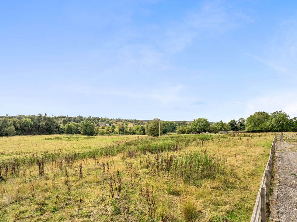 A field with trees and a fence at a property Near Waterhouses