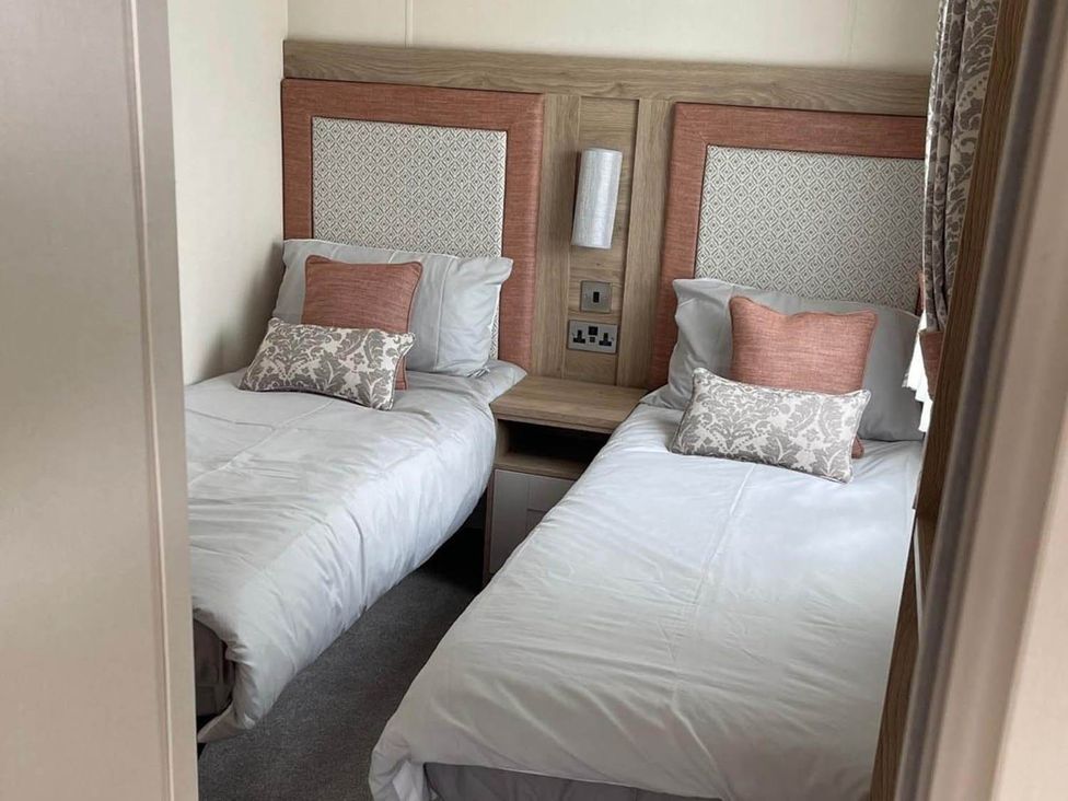A bedroom with twin beds and a bedside table