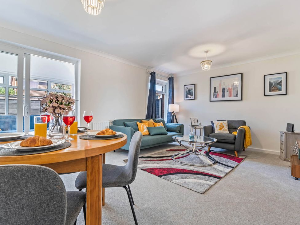 A living room with a dining area and sofa at The Old Barn in Stafford