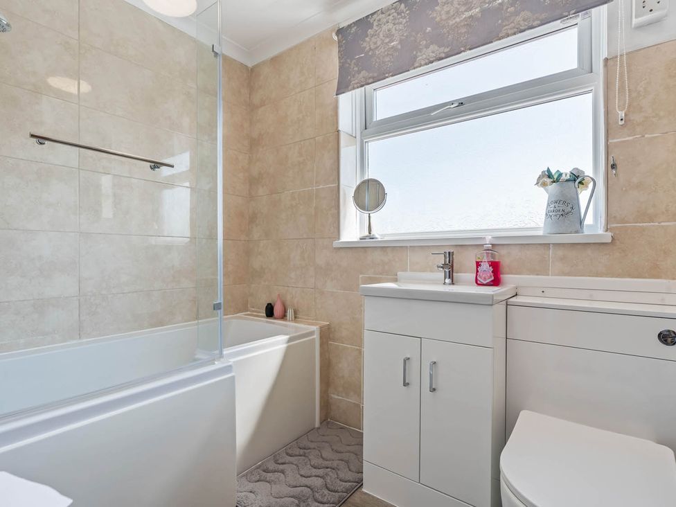 A bathroom with a bathtub and sink at The Old Barn in Stafford