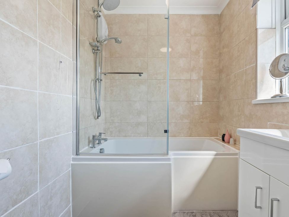 A bathroom with a bathtub and shower at The Old Barn in Stafford