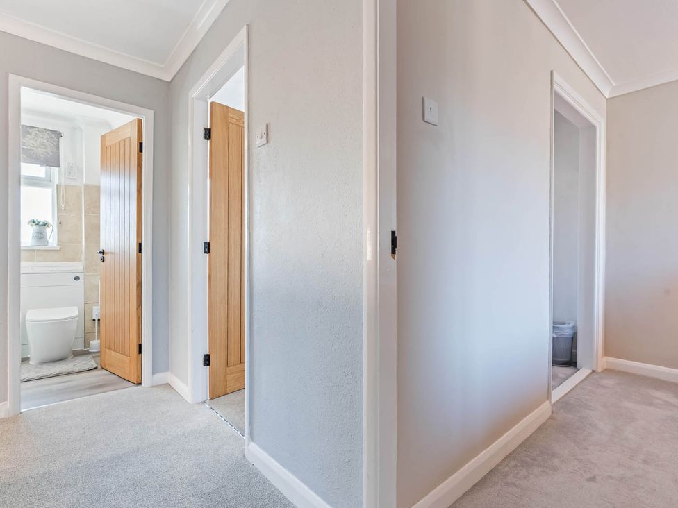 A hallway with doors leading to a bathroom at The Old Barn in Stafford