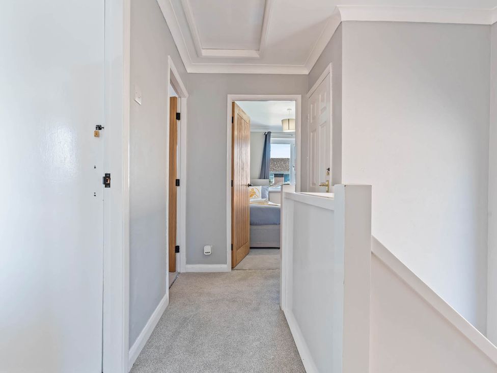 A hallway with doors and a window at 
