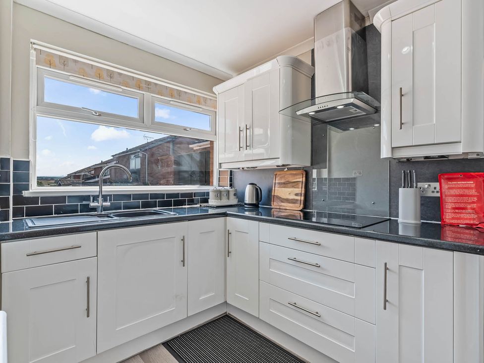A kitchen with cabinets and countertop at the property in Stafford