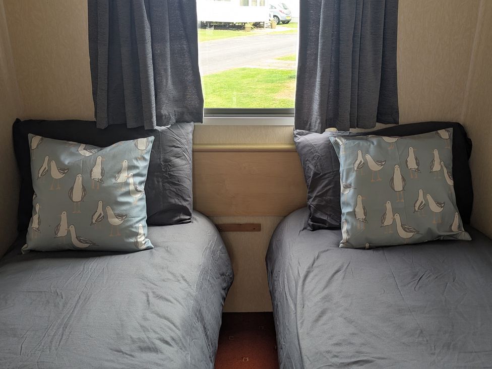 A bedroom with two beds and decorative pillows at 