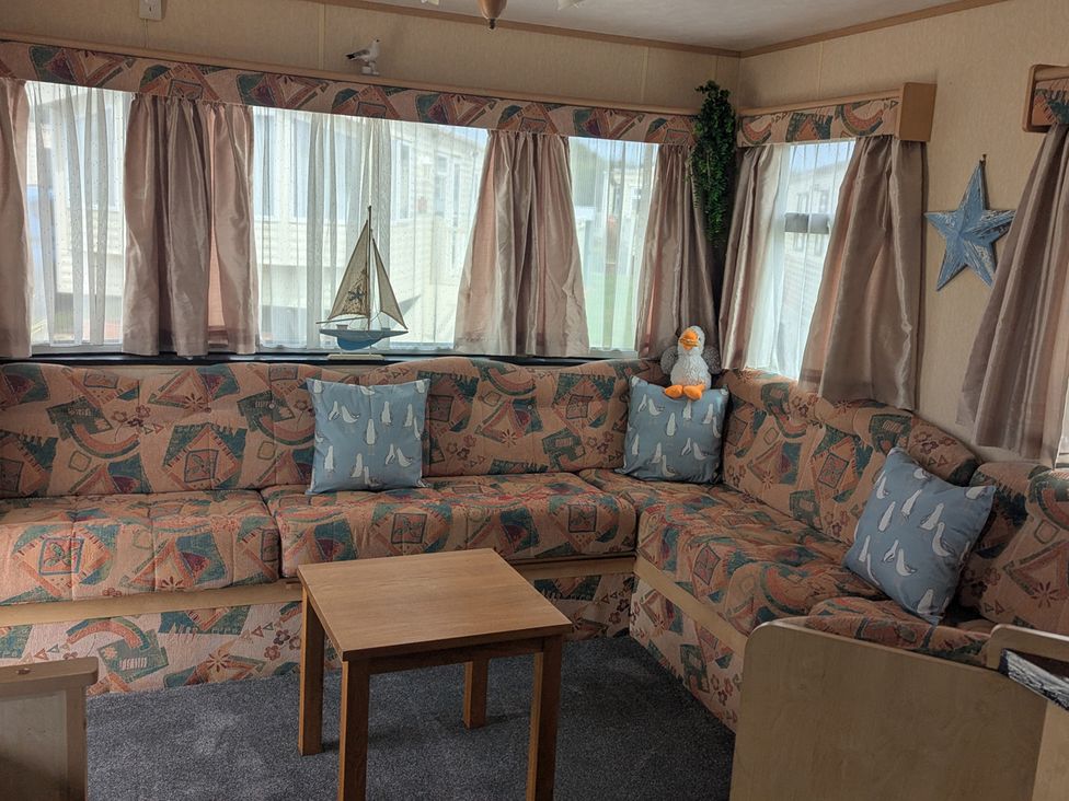 A living room with a sofa and coffee table at  in Anderby Creek