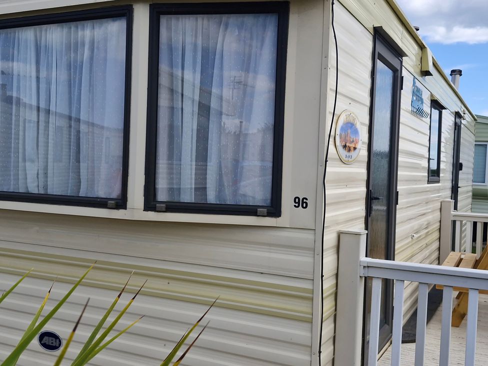 Exterior view of a caravan with windows and door at the caravan park in Anderby Creek