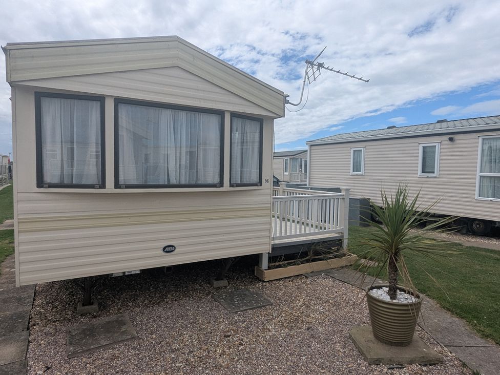 A static caravan with a balcony at a holiday park in Anderby Creek