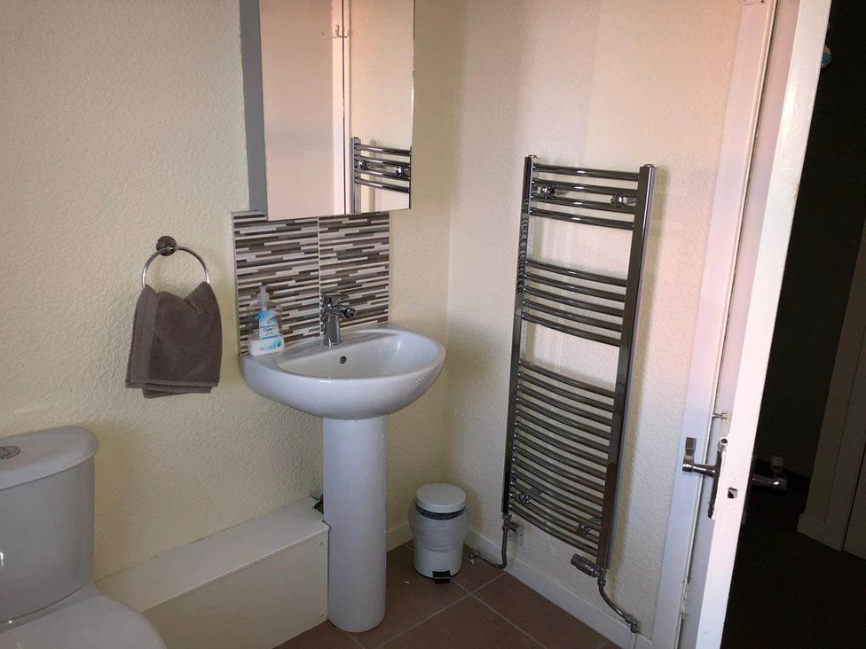 A bathroom with a sink and toilet at PetFriendly Beachfront Sunset Facing Porch Garden in Portmahomack