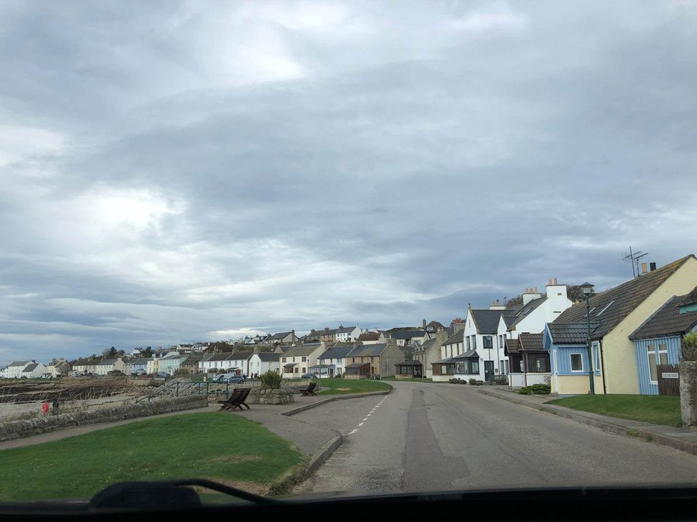 A view of houses and a road at PetFriendly Beachfront Sunset Facing Porch Garden in Portmahomack