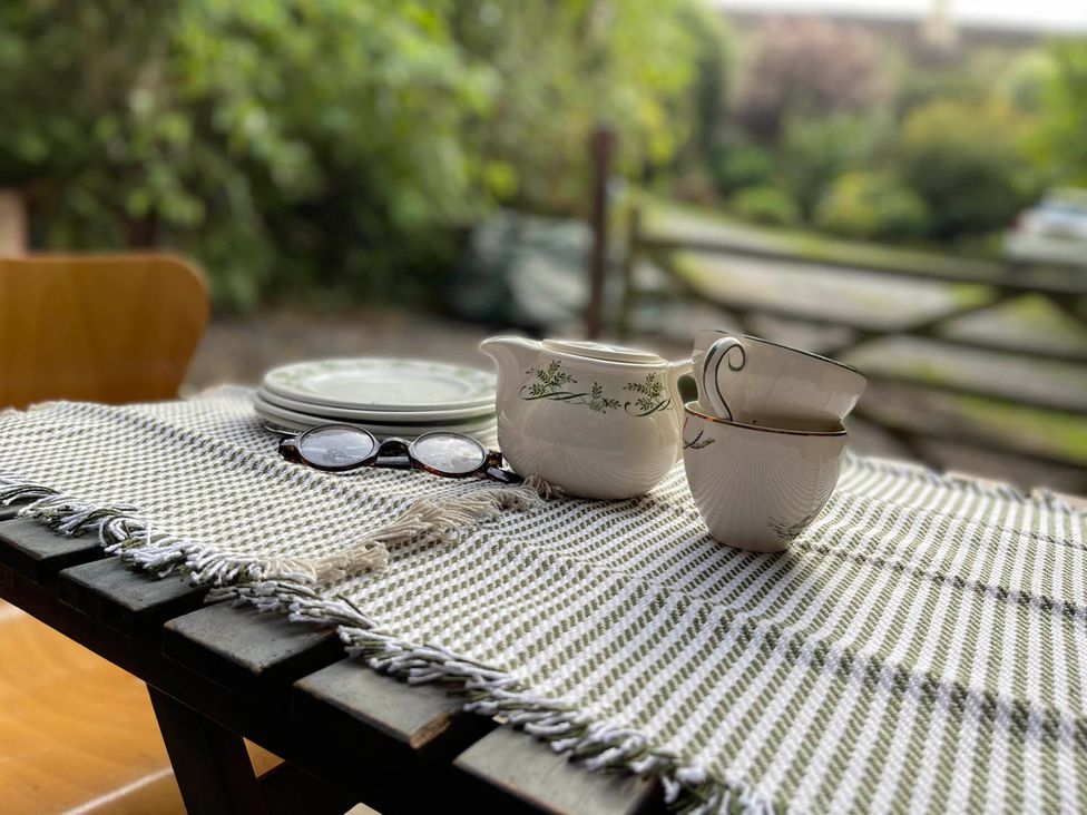 A table with a pitcher and teacup at 