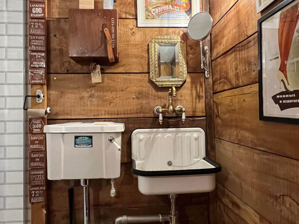 A bathroom with a toilet and sink at The Old Barn in Bovey Tracey