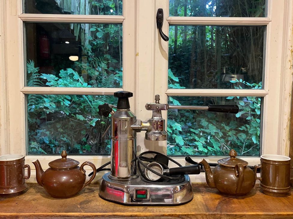 An espresso machine with teapots and mugs at a kitchen in Bovey Tracey