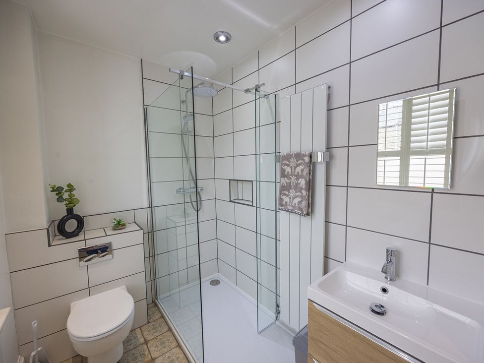 A bathroom with a shower, toilet, and sink at Short Walk to the Beach - 2 Guests - Free Parking in Thurso