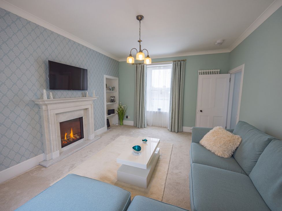 A living room with a fireplace and sofa at Short Walk to the Beach - 2 Guests - Free Parking in Thurso
