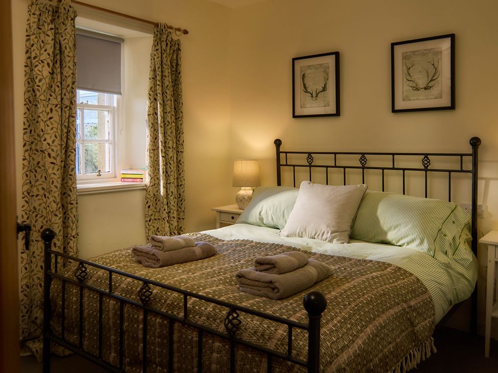 A bedroom with a bed and lamp at The Old Barn near Edinburgh