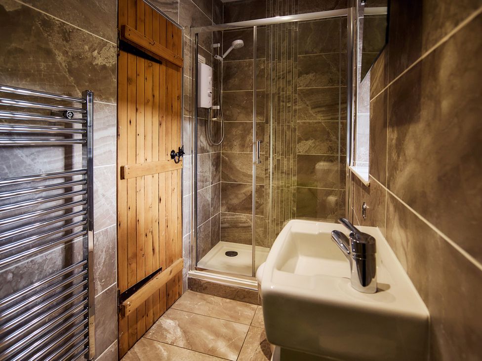A bathroom featuring a shower, sink and towel rail at the property near Edinburgh