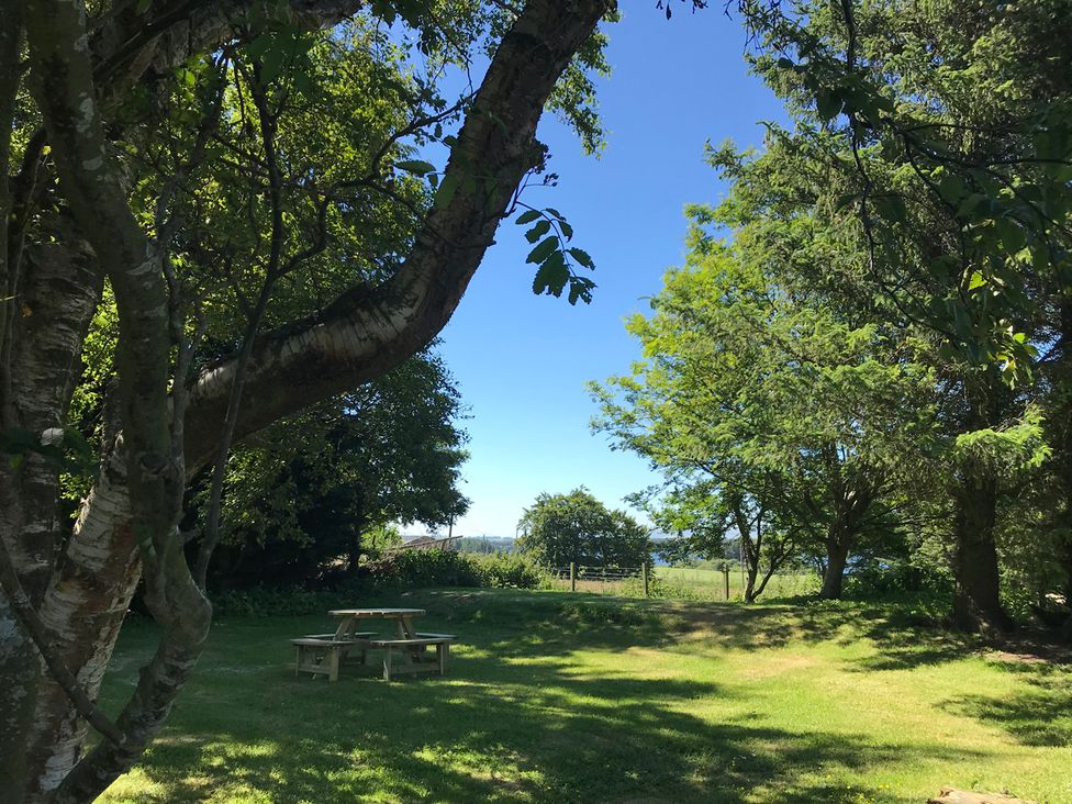 A garden with trees and a picnic table near Edinburgh