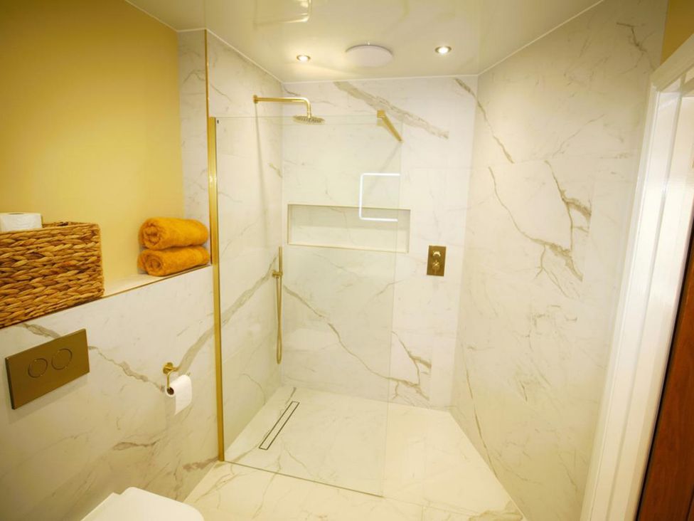 A bathroom with a shower and towels at Newly Refurbished Cottage, sleeping 4 and Central Berwick-Upon-Tweed