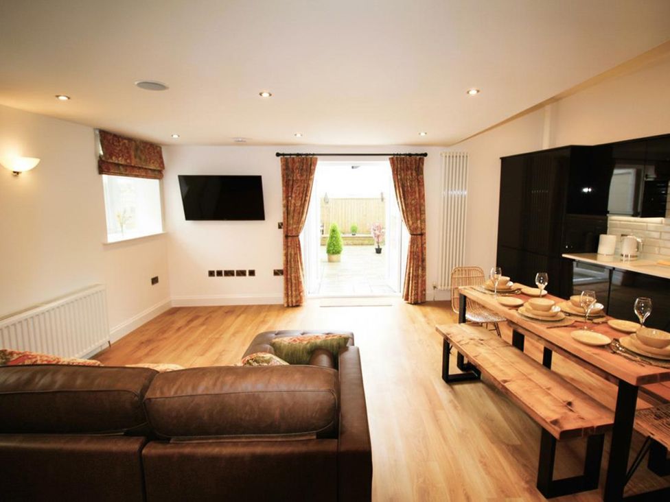 A living room with a television and dining table at Newly Refurbished Cottage, sleeping 4 and Central Berwick-Upon-Tweed