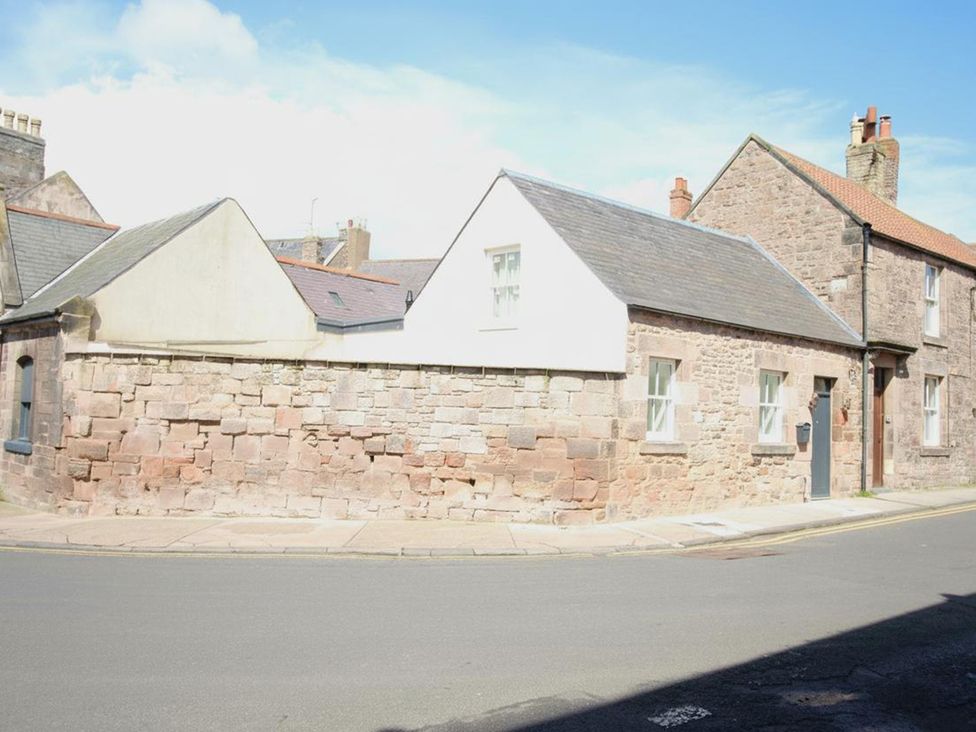 A building with stone walls and sloped roof at Newly Refurbished Cottage, sleeping 4 and Central, Berwick-Upon-Tweed
