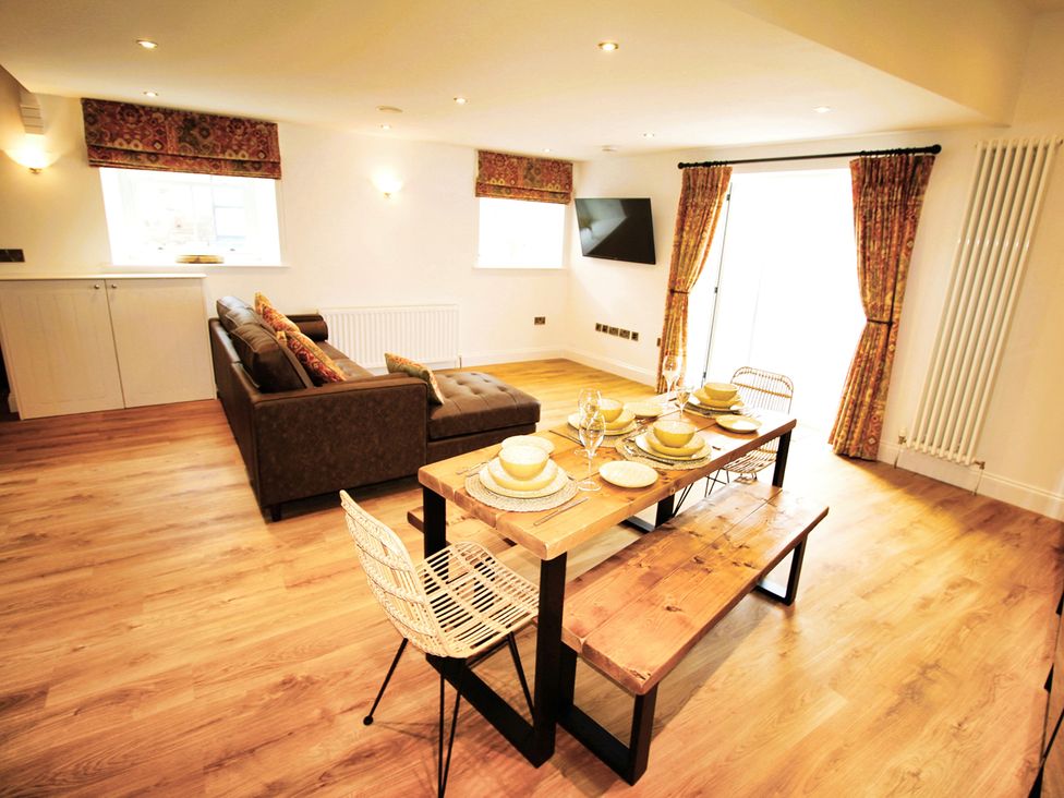 A living room with a sofa and dining table at Newly Refurbished Cottage, sleeping 4 and Central, Berwick-Upon-Tweed