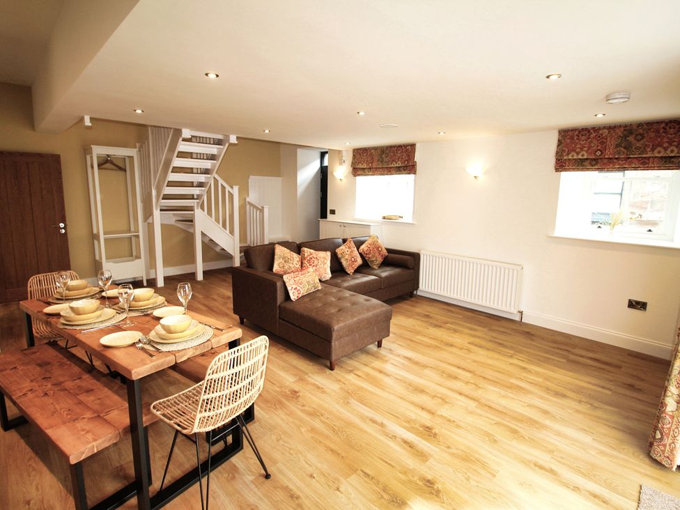 A living room with a dining area and staircase at Newly Refurbished Cottage, sleeping 4 and Central Berwick-Upon-Tweed