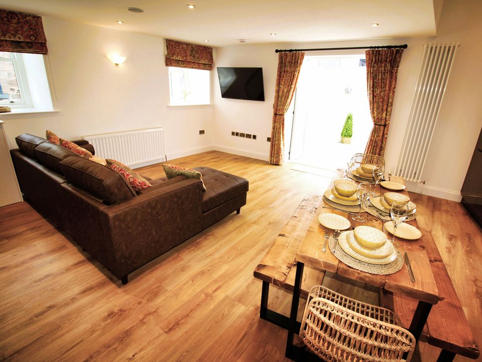 A living room with a sofa and dining table at Newly Refurbished Cottage, sleeping 4 and Central Berwick-Upon-Tweed
