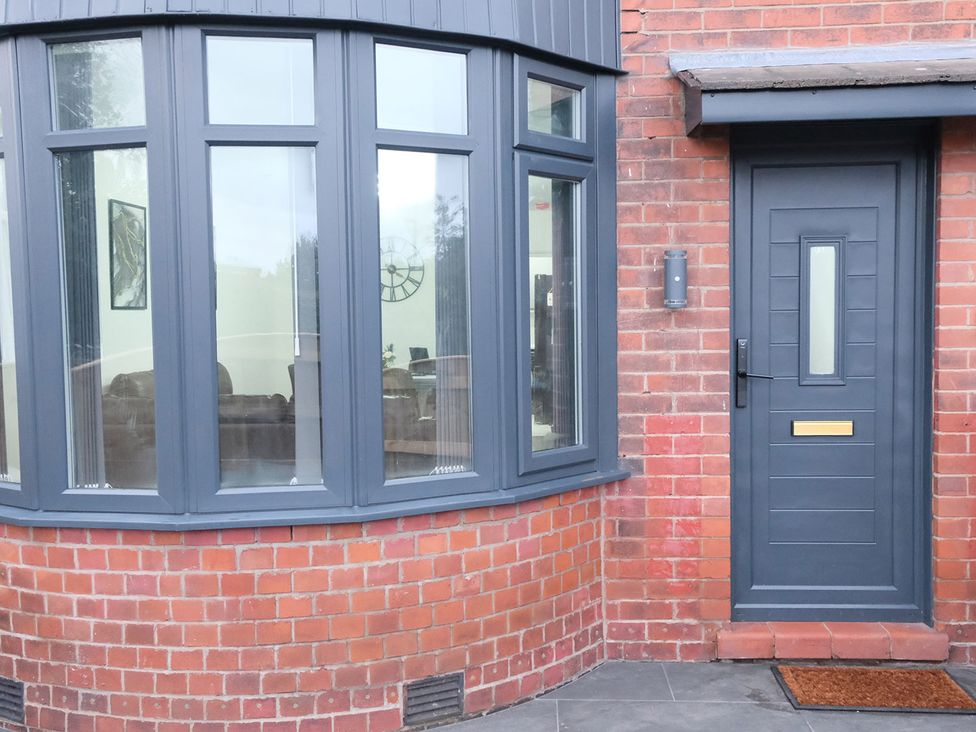 An entryway with a door and large windows at 3 Bedroom, Modern House in Manchester