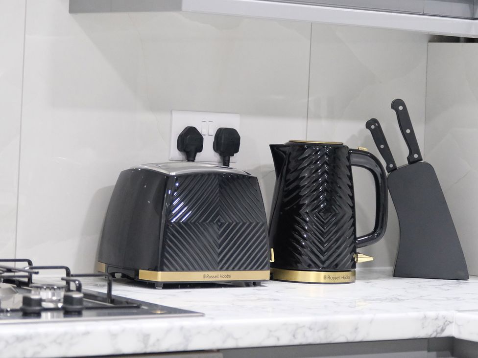 A toaster and kettle on the counter at 3 Bedroom, Modern House in Manchester