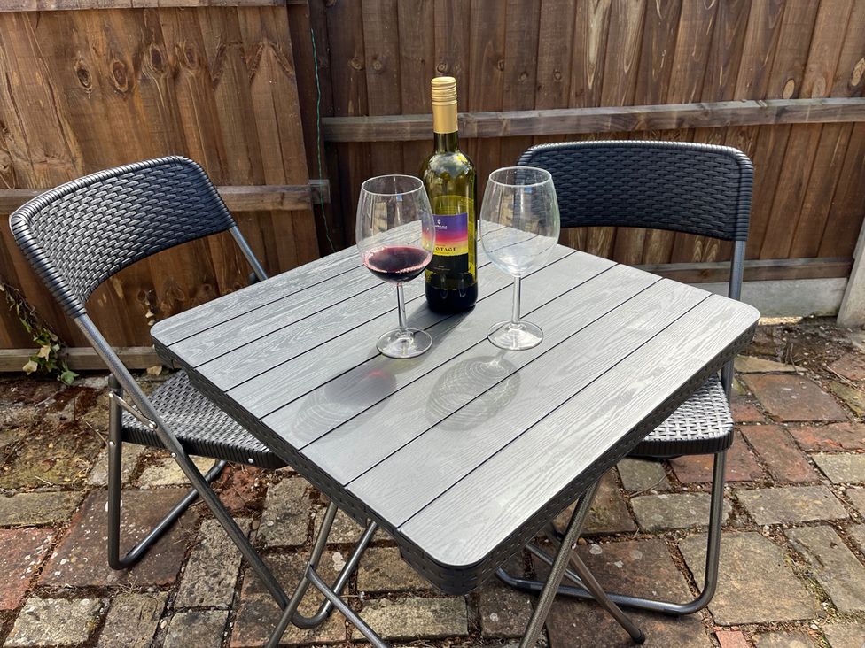 A table with chairs and wine glasses at Historic Cottage on the Suffolk border, Harleston Norfolk