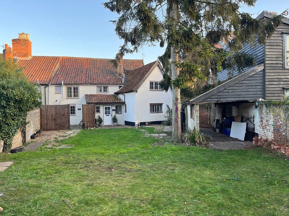 A garden with a house and garage at Historic Cottage on the Suffolk border, Harleston Norfolk