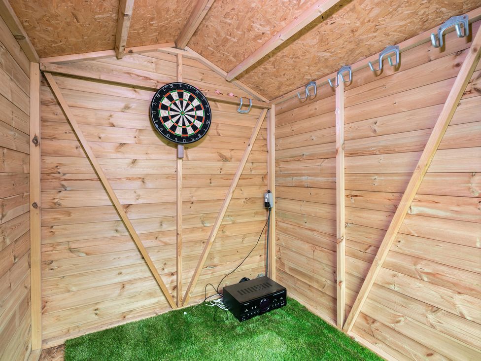 A snug with a dartboard and speaker at House, sleeping 4 with Garden and Parking Ashford