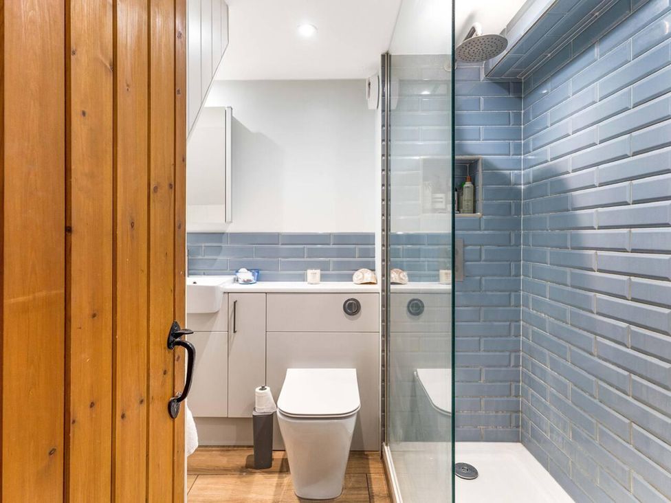 A bathroom with a shower and sink at Little Braybrooke Cottage- Saffron Walden