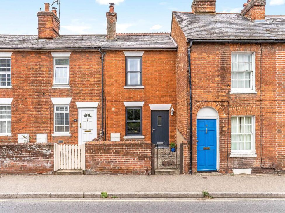 Three brick houses with different colored doors at Little Braybrooke Cottage- Saffron Walden