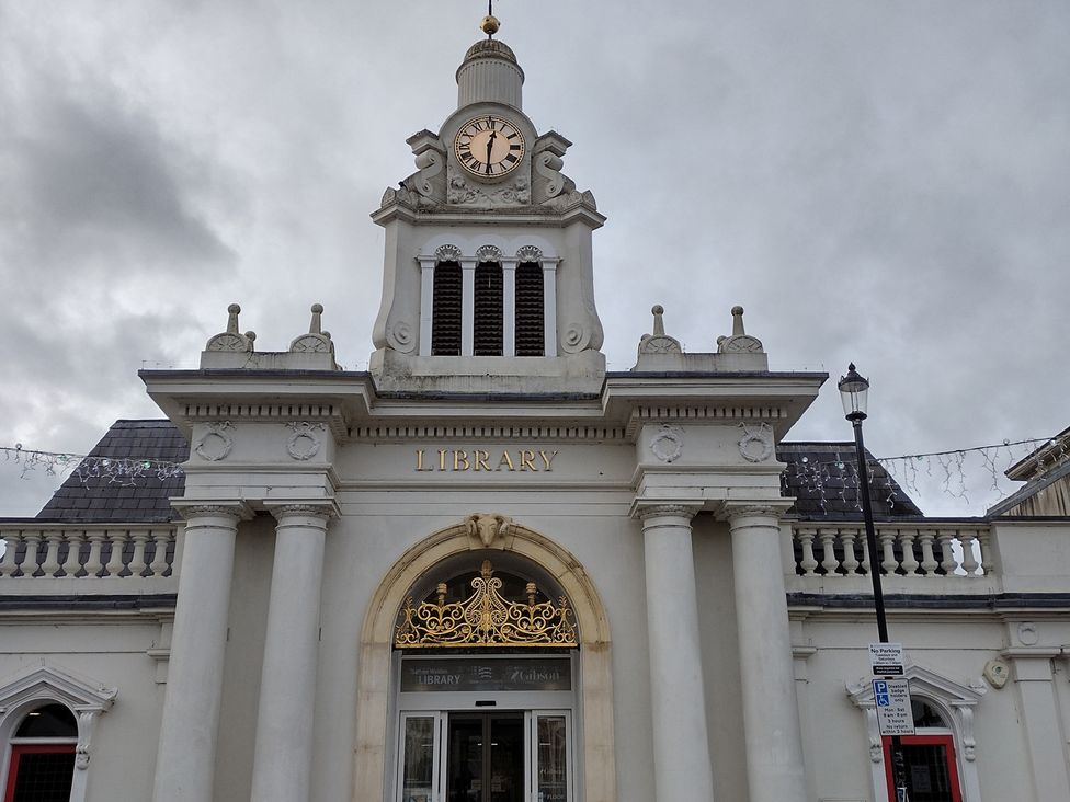 A library building with clock and decorative entrance in Saffron Walden